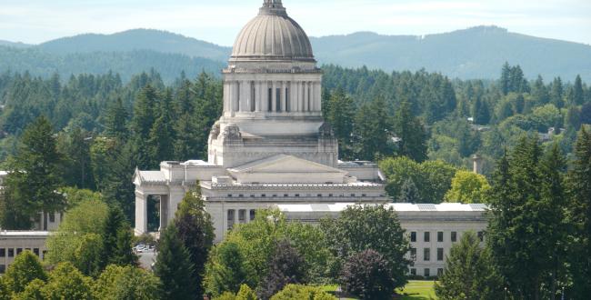 Long-range photos of the Legislative Building in Olympia, Washington, with mountain range in the background