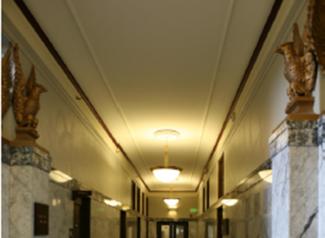 Interior photo of the Capitol Court Building showing the ceiling light fixtures and the eagle statues