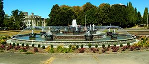 An image of the Tivoli Fountain with water in it and operating on July 28, 2017 looing northeast with the Capitol Court Building in the background.