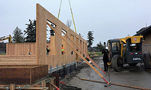 Cross Laminated Timber wall panel placed in a construction project with pre-cut spaces for doors and windows