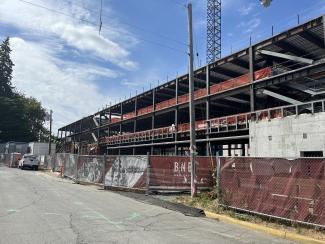 An outdoor scene showing the Joel Pritchard Building construction site. The site is fenced off for public safety.