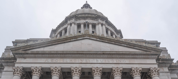 Looking up to the top third of the Washington State Legislative Building from below