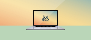 An open laptop with the Washington State Employee Assistance Program (EAP) logo on the screen.