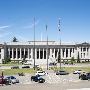 View of Temple of Justice from the steps of the Legislative Building, with cars parked in front. Shows portion of detour route.