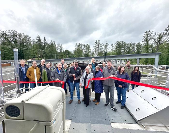 Ribbon cutting at the North Bend wastewater treatment plant drew a crowd of employees.