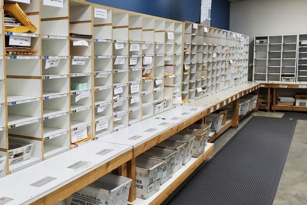 The mail room's sort wall containing hundreds of cubbies for incoming and outgoing mail.