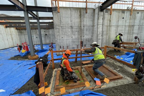 Concrete workers get rebar ready for a concrete foundation pour on a public works project