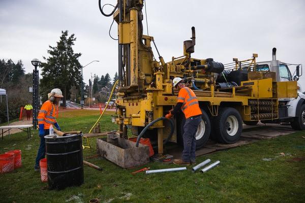 Crews operating a geotechnical drilling machine take samples.