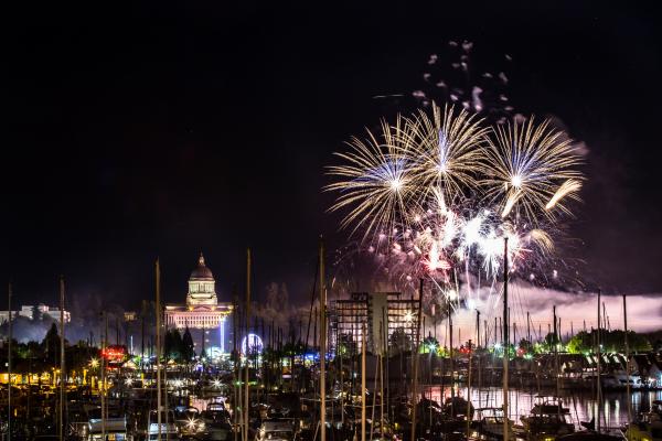 Fireworks explode in the night sky over Capitol Lake as part of the annnual Lakefair event